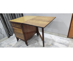 A wooden folding dining table with storage - Image 7/10